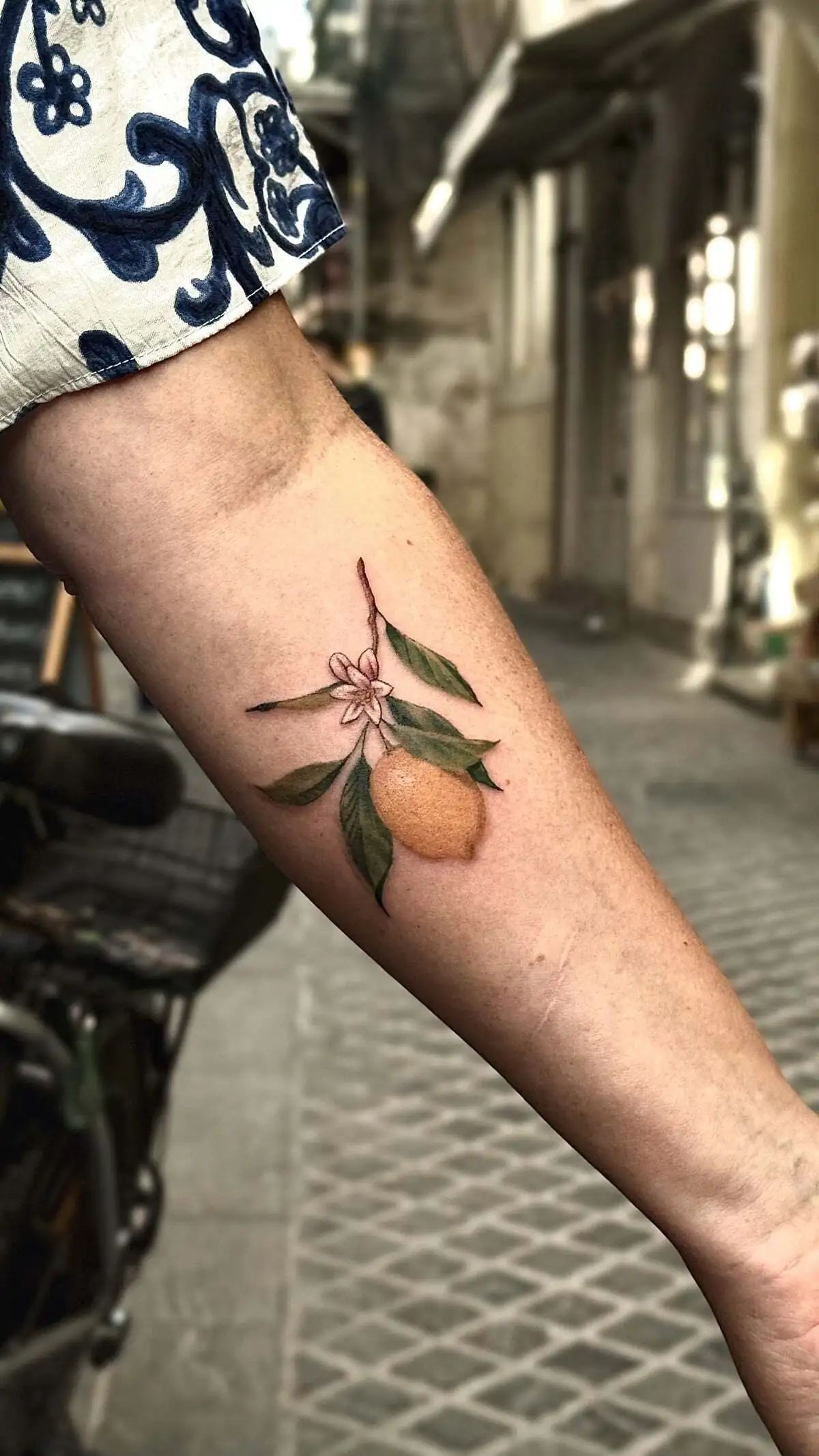 lemon branch color forearm tattoo