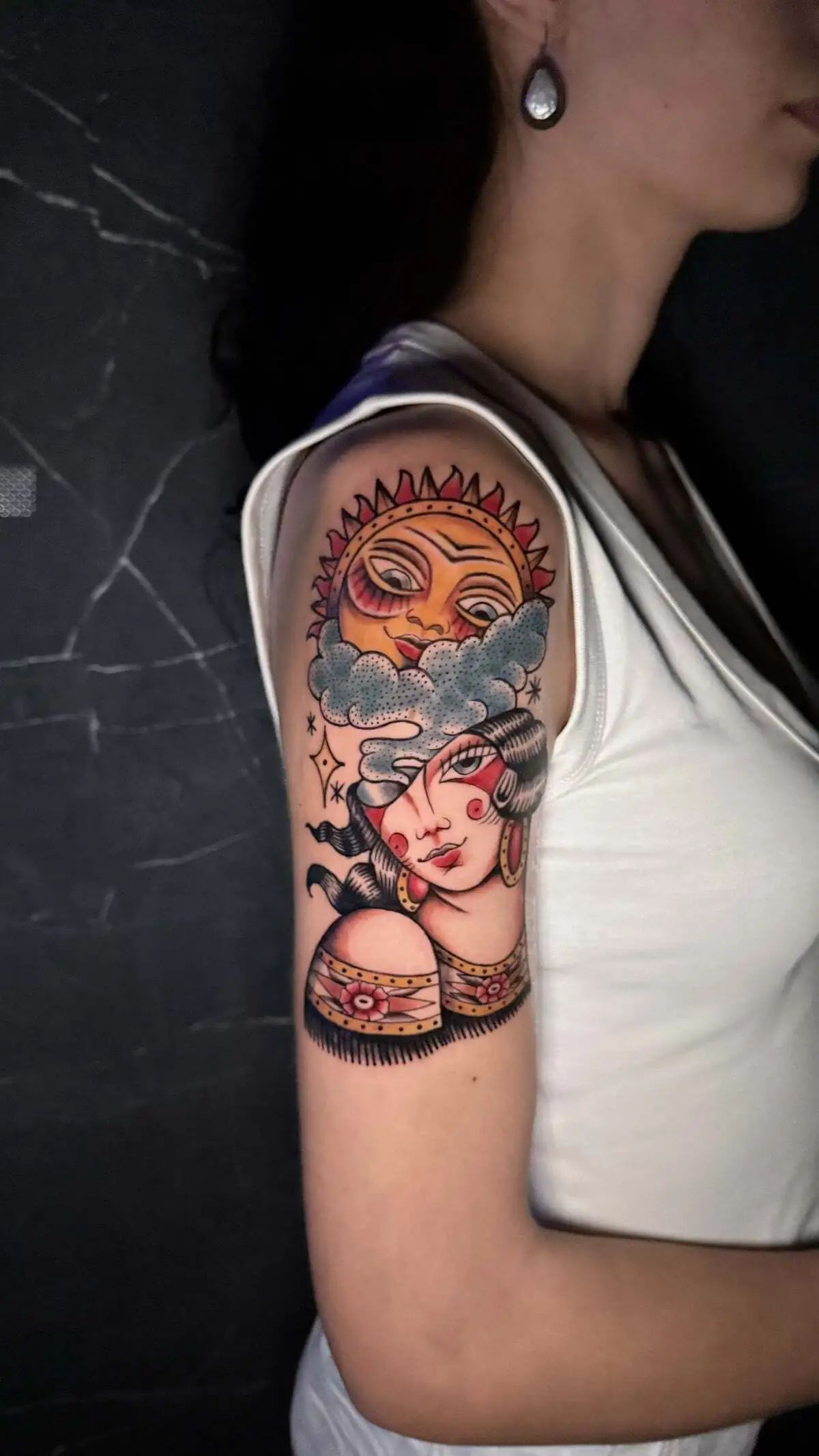 traditional woman sun clouds upper arm tattoo
