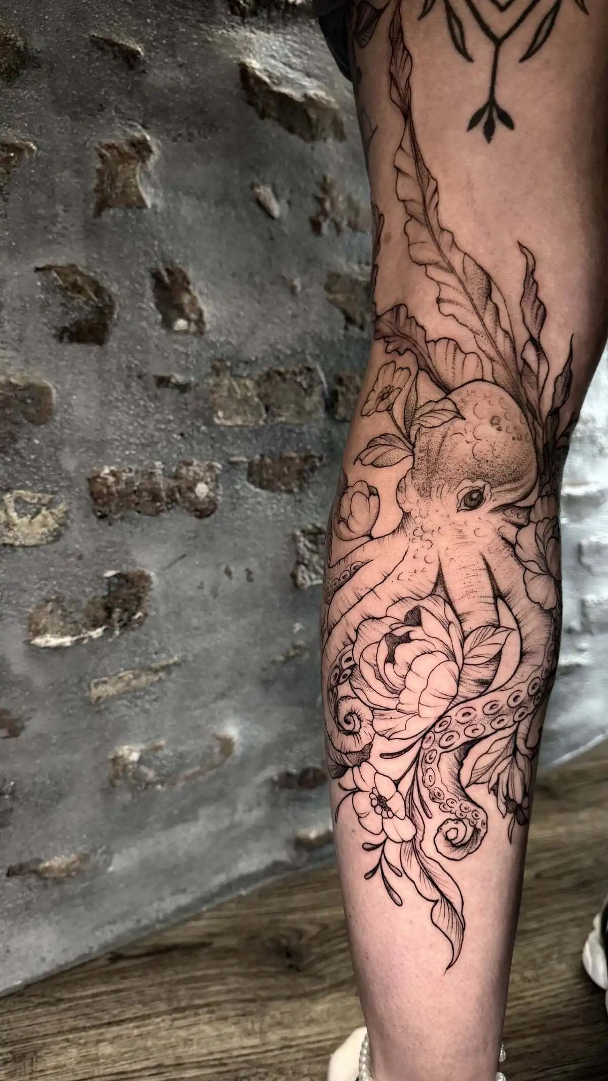 octopus flowers fine line forearm tattoo