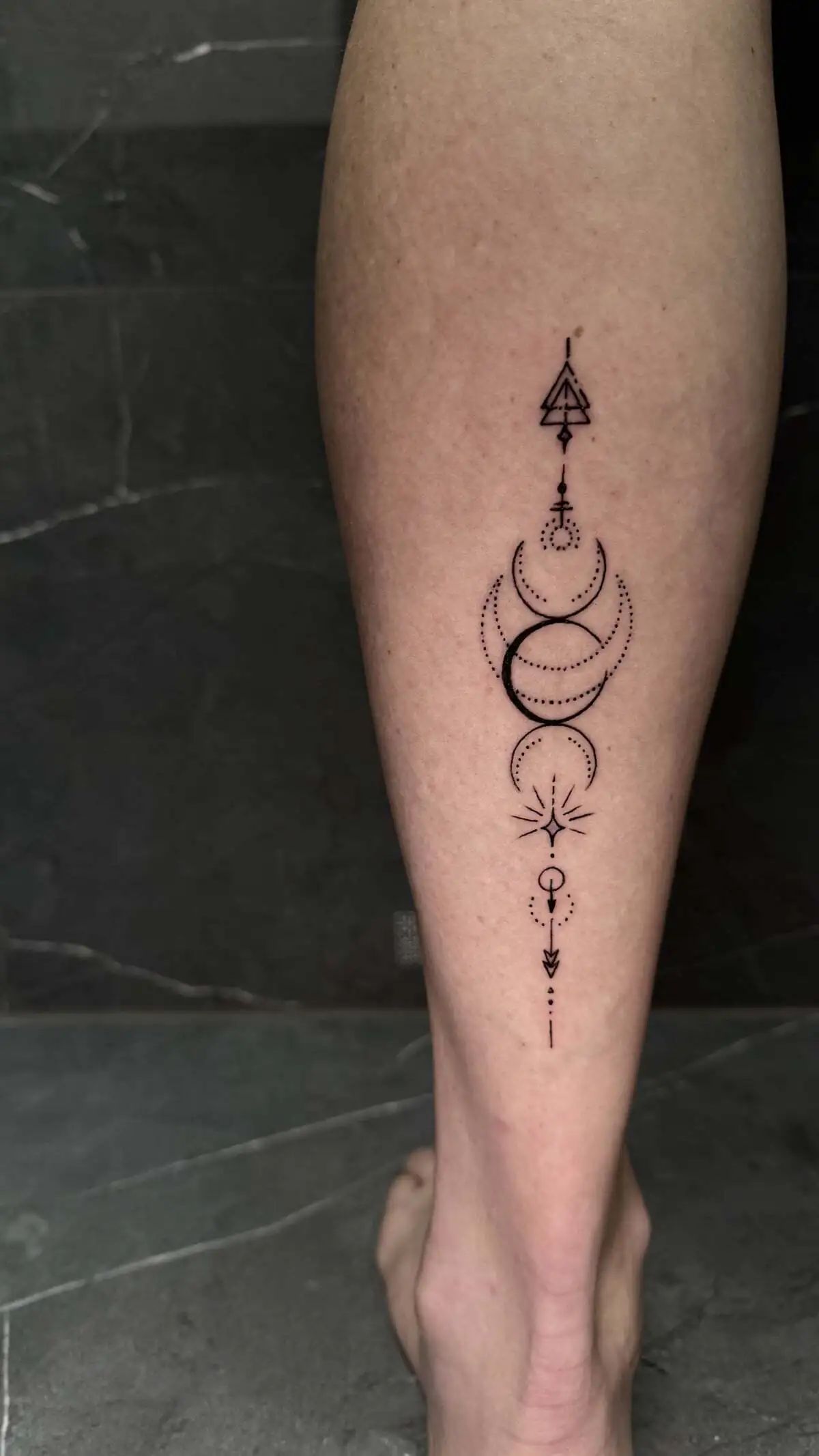 geometric moon phases vertical calf tattoo