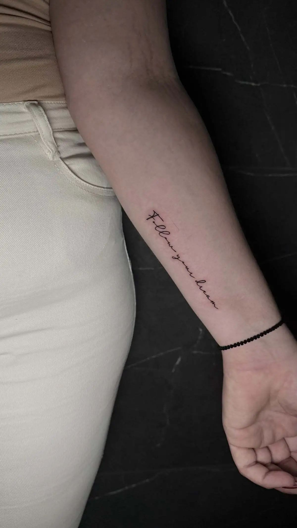 minimal script quote forearm tattoo