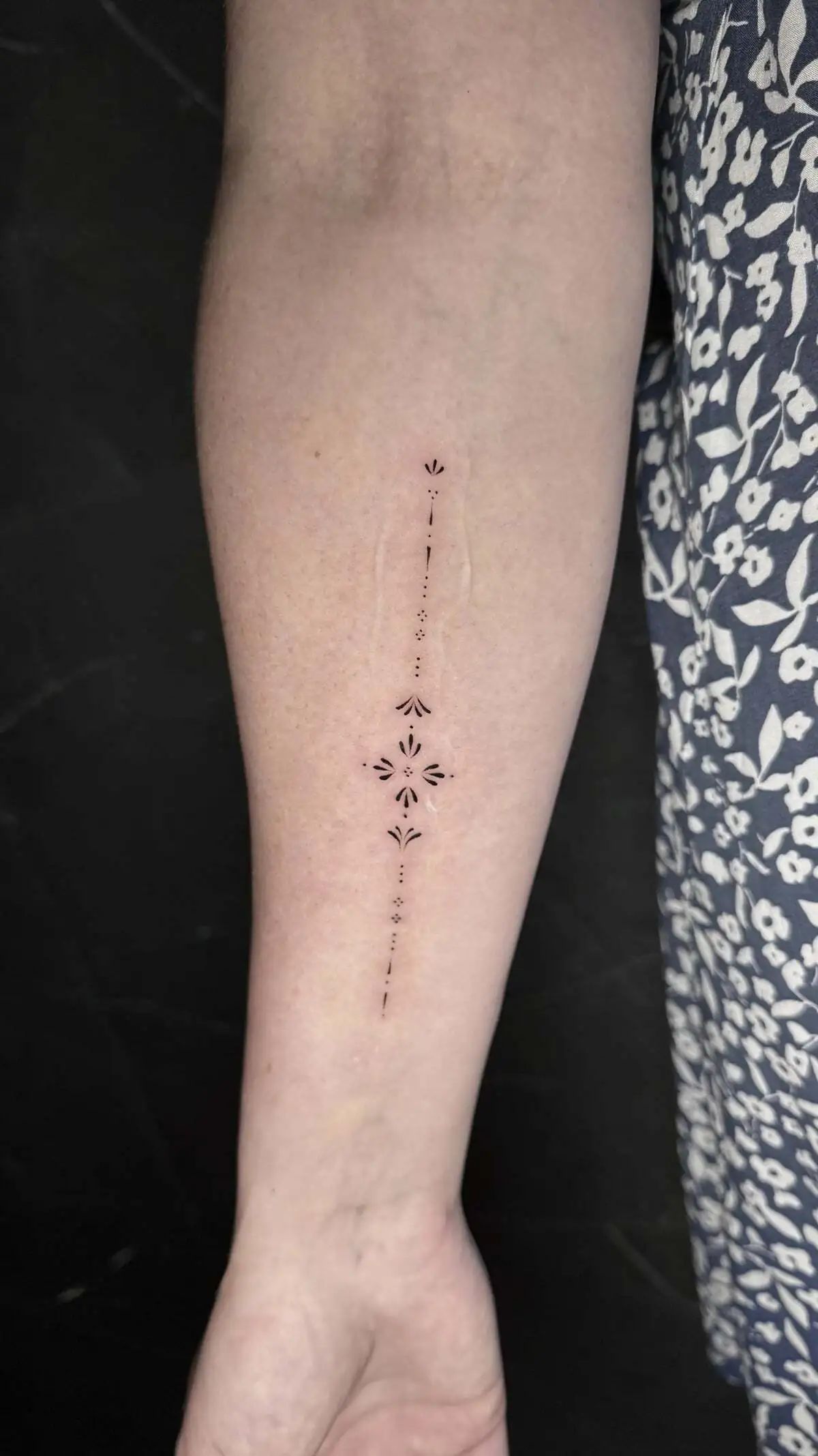minimal ornamental line forearm tattoo