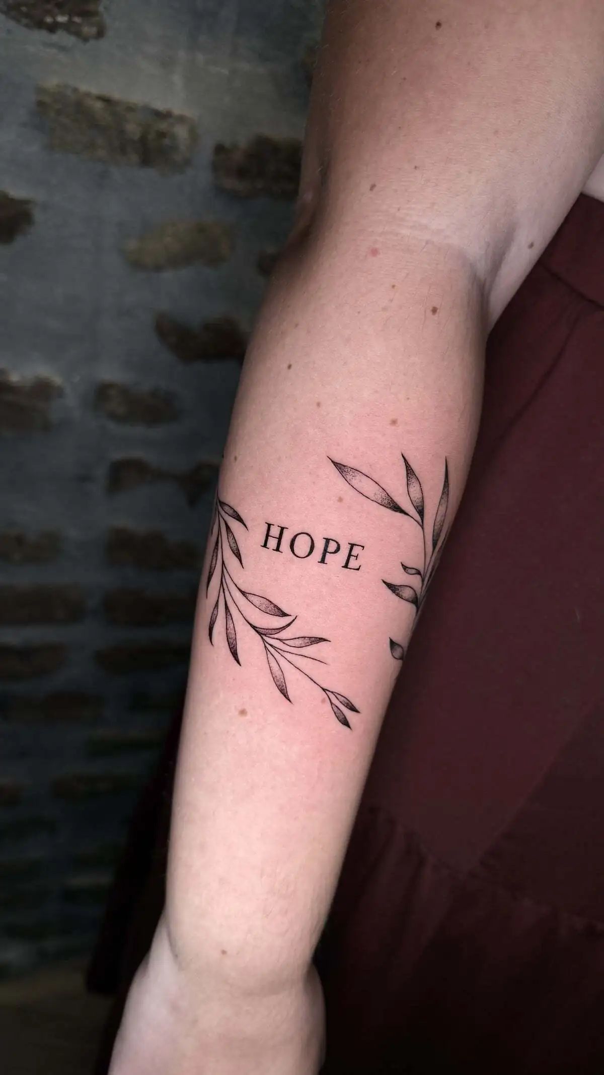 hope lettering olive branches forearm tattoo