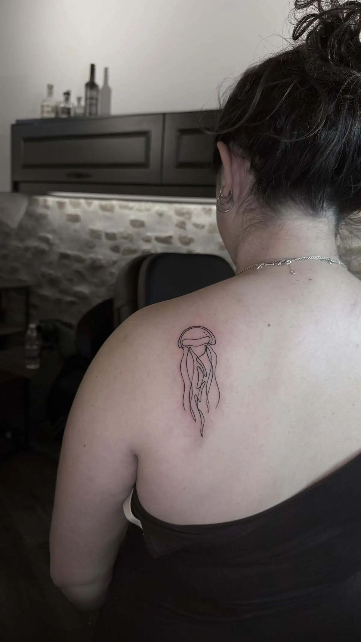 minimal jellyfish line upper back tattoo