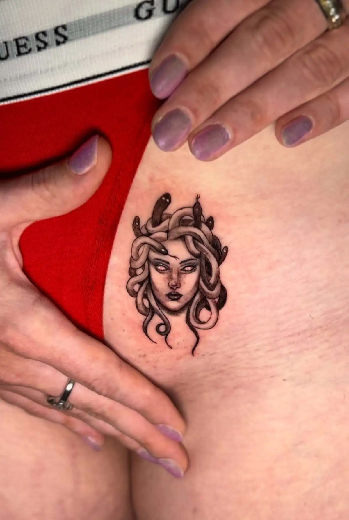 medusa head micro realism thigh tattoo